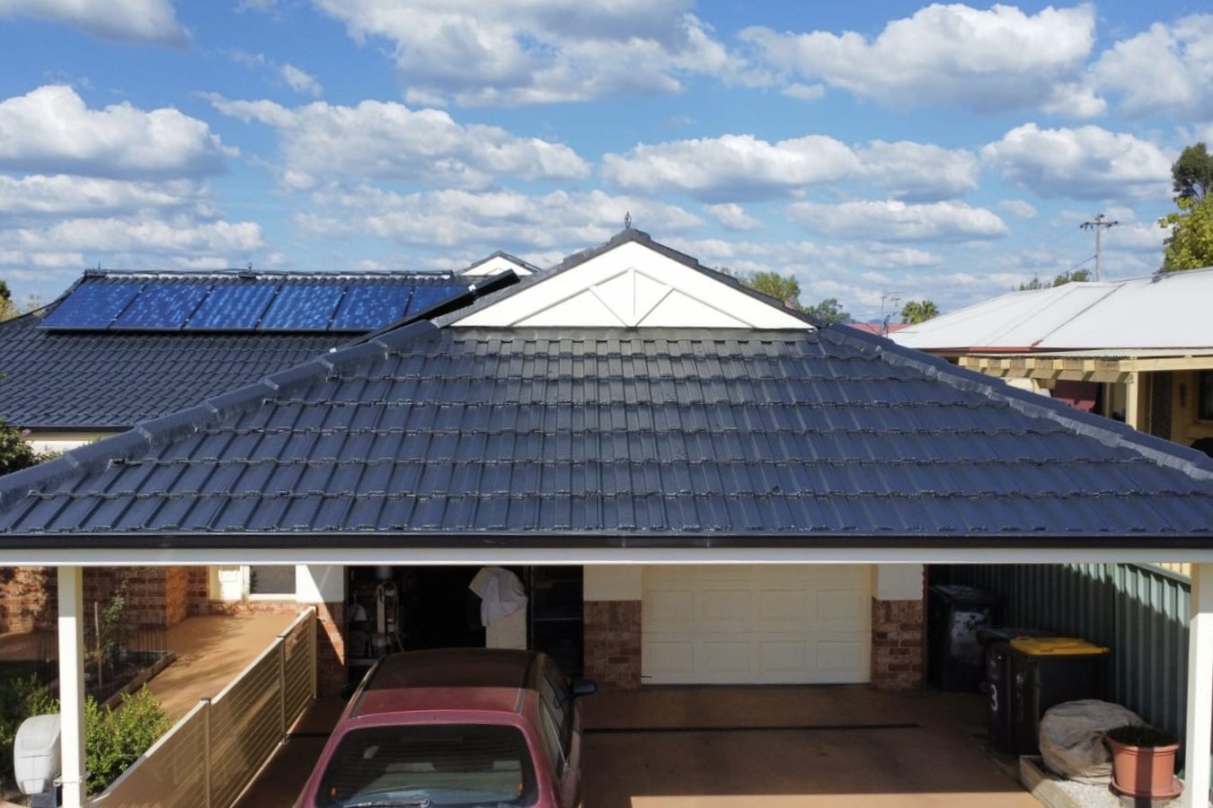 Home with a deep charcoal tile roof