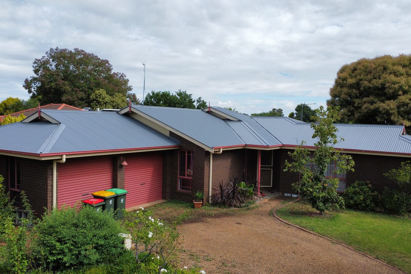 Suburban home with a clean grey green roof